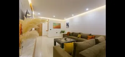 a living room with a couch and a table at Modern 3-Bed retreat in Gueliz near Train station in Marrakech
