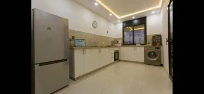 a large kitchen with a refrigerator and a washing machine at Modern 3-Bed retreat in Gueliz near Train station in Marrakech