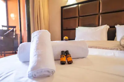a hotel room with two towels and two bottles on a bed at River Palm, bel appartement 2 ch Piscine résidence in Marrakech