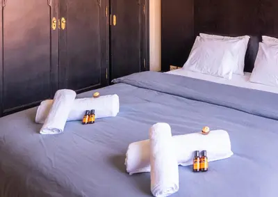 a bedroom with two beds with towels and candles on them at River Palm, bel appartement 2 ch Piscine résidence in Marrakech