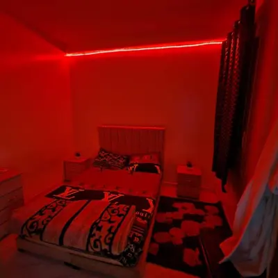 a red room with a bed and a red light at Apartment in the heart of enchanting Marrakech in Marrakech