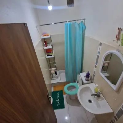 a bathroom with a sink and a toilet and a mirror at Apartment in the heart of enchanting Marrakech in Marrakech