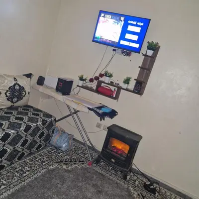 a living room with a fireplace and a tv at Apartment in the heart of enchanting Marrakech in Marrakech