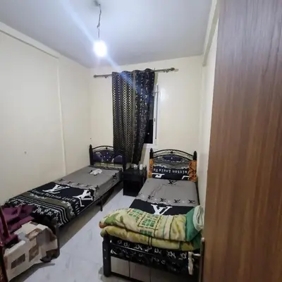 a room with two beds and a window at Apartment in the heart of enchanting Marrakech in Marrakech