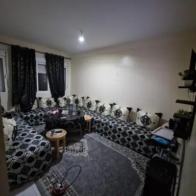 a living room with couches and tables in a room at Apartment in the heart of enchanting Marrakech in Marrakech