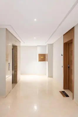 an empty room with white walls and wooden doors at Syra House Residence Moderne 2 Piscine Jacuzzi Parking in Marrakech