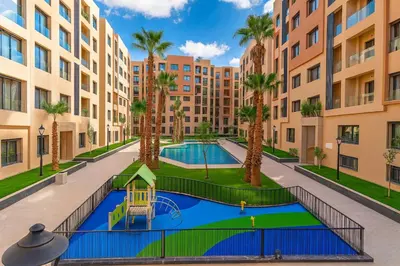 an image of an apartment complex with a swimming pool and palm trees at Syra House Residence Moderne 2 Piscine Jacuzzi Parking in Marrakech