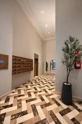 a hallway with a tree in a pot on the floor at Syra House Residence Moderne 2 Piscine Jacuzzi Parking in Marrakech