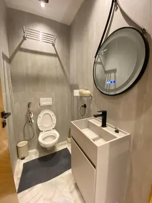 a bathroom with a toilet and a sink and a mirror at Hermès home in Marrakech