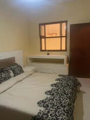 a bedroom with a large bed with a window at Espacieuse in Marrakech