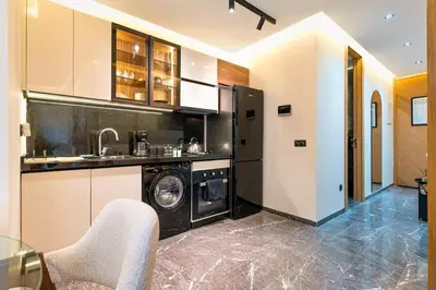 a kitchen with a washer and dryer in a room at Quiet & Secure Apt - Fast WiFi - Central Area in Marrakech