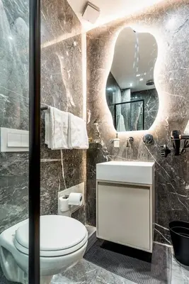 a bathroom with a toilet and a sink and a mirror at Quiet & Secure Apt - Fast WiFi - Central Area in Marrakech