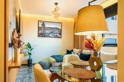 a living room with a table and chairs at Quiet & Secure Apt - Fast WiFi - Central Area in Marrakech