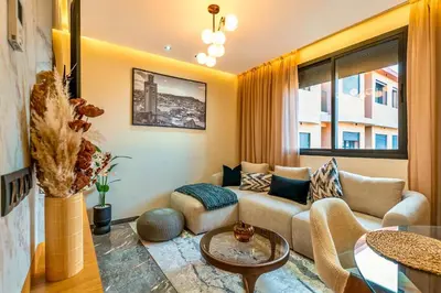 a living room with a couch and a table at Quiet & Secure Apt - Fast WiFi - Central Area in Marrakech