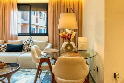 a living room with a table and a couch at Quiet & Secure Apt - Fast WiFi - Central Area in Marrakech