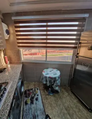 a kitchen with a stove and a window with a table at Cozy apartment, traditional style, mountain view in Marrakech