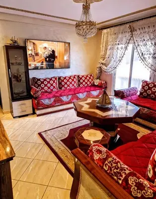 a living room with red couches and a table at Cozy apartment, traditional style, mountain view in Marrakech