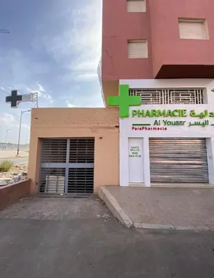 a building with a parking lot in front of a garage at Cozy apartment, traditional style, mountain view in Marrakech