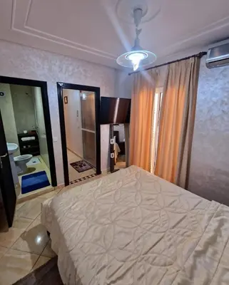 a bedroom with a large bed and a large mirror at Cozy apartment, traditional style, mountain view in Marrakech