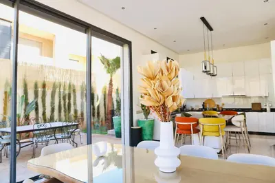 a kitchen and dining room with a table and chairs at Luxury Villa Hedi in Marrakech