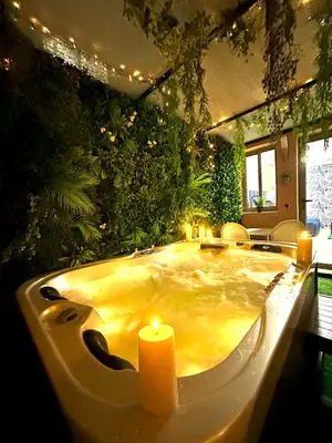 a large bath tub with two candles in a room at Majorelle blue SPA retreat in Marrakech