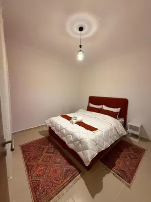 a bedroom with a large bed with a rug at Atlas view in Marrakech