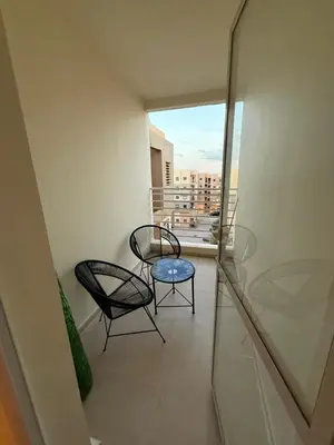 a balcony with two chairs and a table on it at Atlas view in Marrakech