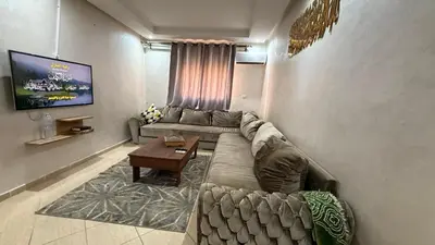 a living room with a couch and a table at Atlas view apartement in Marrakech