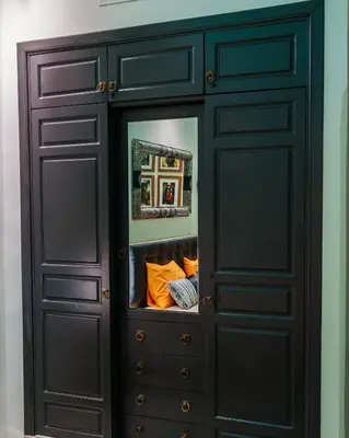 a dark wooden cabinet with a mirror inside at Eden Palmyra in Marrakech