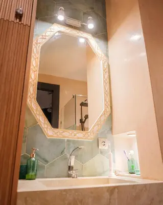 a bathroom with a sink and a mirror at Eden Palmyra in Marrakech