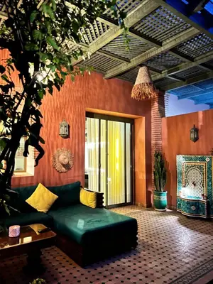a living room with a green couch in a room at Eden Palmyra in Marrakech