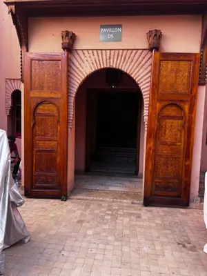 an entrance to a building with two wooden doors at Eden Palmyra in Marrakech