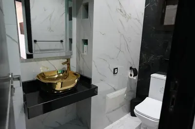 a bathroom with a gold sink and a toilet at The ApexYour skyward sanctuary in the city's heart in Marrakech