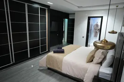 a bedroom with a large bed and a mirror at The ApexYour skyward sanctuary in the city's heart in Marrakech