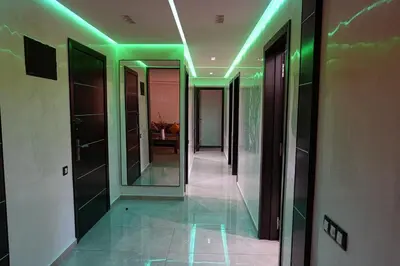 a hallway with green lights in a building at The ApexYour skyward sanctuary in the city's heart in Marrakech