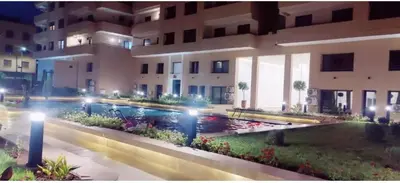 a swimming pool in front of a building at night at Modern Duplex Apartment in Marrakech for family only - Comfortable Quiet in Marrakech