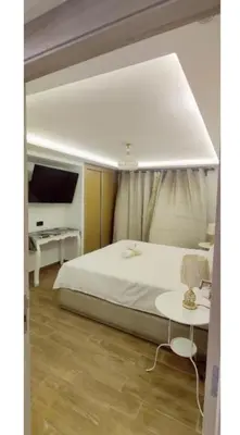 a bedroom with a white bed and a tv at Modern Duplex Apartment in Marrakech for family only - Comfortable Quiet in Marrakech