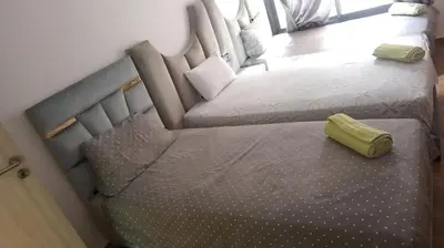 a bedroom with two twin beds and a yellow pillow at Modern Duplex Apartment in Marrakech for family only - Comfortable Quiet in Marrakech