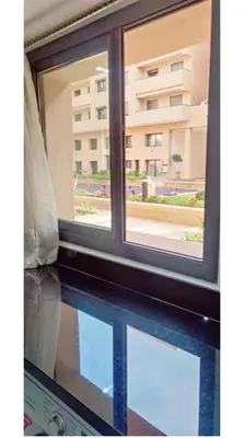 an open window with a view of a building at Modern Duplex Apartment in Marrakech for family only - Comfortable Quiet in Marrakech