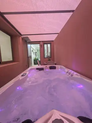 a jacuzzi tub with purple lights in a room at Majorelle green Spa Suite in Marrakech