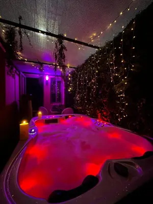 a hot tub with red dye in a room with lights at Majorelle green Spa Suite in Marrakech
