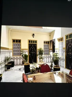 a large lobby with chairs and tables and plants at Hôtel Zagora sur in Marrakech