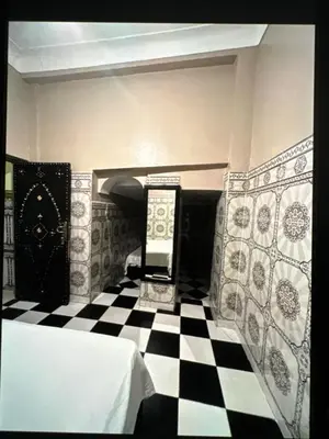 a room with a black and white checkered floor at Hôtel Zagora sur in Marrakech