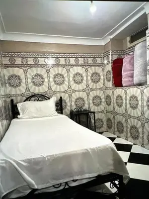 a bedroom with a bed and a checkerboard wall at Hôtel Zagora sur in Marrakech
