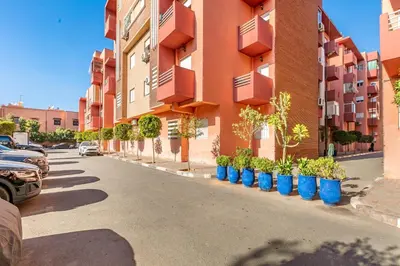 a row of blue potted plants on the side of a building at Harmony Elegance and Comfort near Gueliz in Marrakech