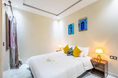 a white bedroom with two beds and two lamps at Harmony Elegance and Comfort near Gueliz in Marrakech