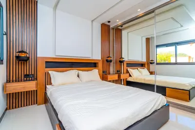 a bedroom with two beds and a mirror at Luxury Apartment in Central Hivernage in Marrakech