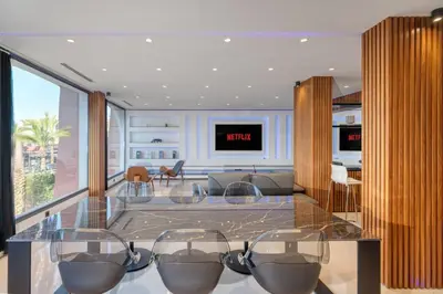 a living room with a glass table with chairs at Luxury Apartment in Central Hivernage in Marrakech