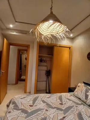 a bedroom with a bed and a light at Studio meublé Guéliz in Marrakech
