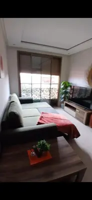 a living room with a couch and a table at Studio meublé Guéliz in Marrakech